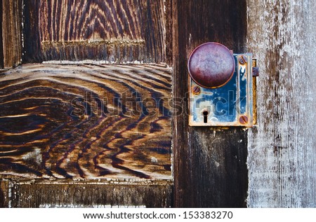 This old weathered door knob and lock could tell stories about the past.