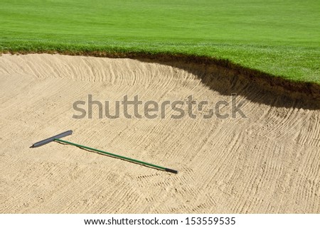 There is a sand rake in the bunker to smooth out footsteps and divots.