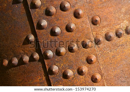 Rusty boiler old rivets close up.