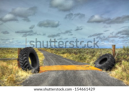 These old tractor tires have been recycled to be part of a cattle guard on this ranch.