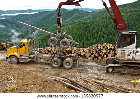 The loader is used to lift the log truck trailer from the truck.