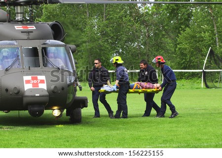 Eugene, Oregon, USA Â?Â? May 2, 2012: Eugene, OR Emergency Services and National Guard work in a disaster drill. Unidentified firemen carried injured person to load on helicopter.