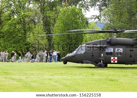 Eugene, Oregon, USA  May 2, 2012: Eugene, OR Emergency Services and National Guard work in a disaster drill. The unidentified walking injured are waiting to board a helicopter on the grass field.