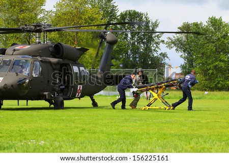 Eugene, Oregon, USA  May 2, 2012: Eugene, OR Emergency Services and National Guard work in a disaster drill. The unidentified firemen are returning from transferring an injured person on helicopter.