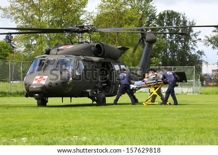 EUGENE, OREGON, USAÂ?Â? May 2, 2012: In Eugene, OR the local Emergency Services and National Guard work in a disaster drill. The firemen carry an injured person on a gurney to the helicopter.