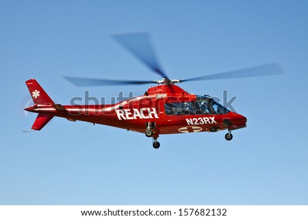NEWPORT, OREGON, USA July 23, 2012: In coastal Newport, OR medical personnel boarded the helicopter and the pilot has taken off and flying away to transport the patient to another medical facility.