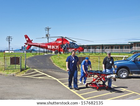 NEWPORT, OREGON, USAÂ?Â? July 23, 2012: In Newport, OR medical personnel are going to the hospital with a gurney to transport an injured person to the helicopter on a landing pad next to the hospital.