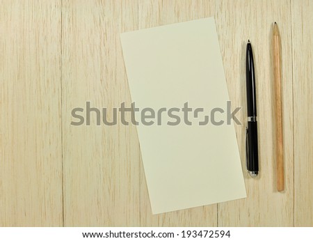 Note paper with pen and pencil on office wooden table