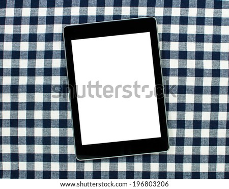 Digital tablet computer with isolated screen on  table linen.