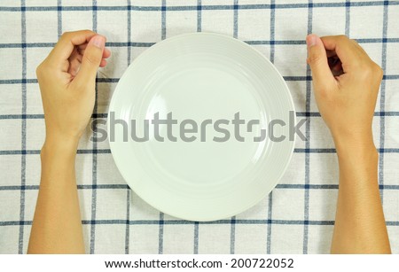 Man sitting at the dinner table and empty plate