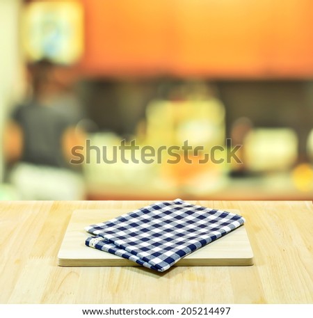Empty blue checkered table and kitchen background. Great for product display montages.