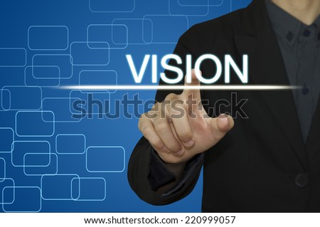 Business man  pointing to Vision on computer screen.