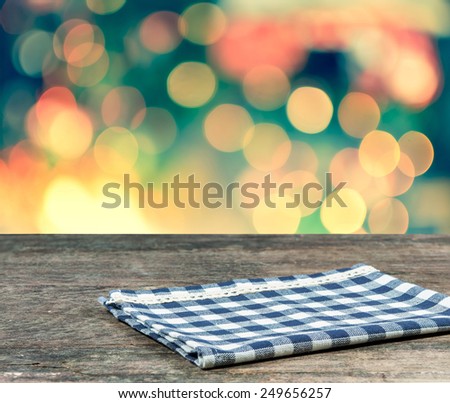 blue clothes on wood table, Abstract circular colorful bokeh background.