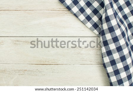 Blue tablecloth on white wooden table.
