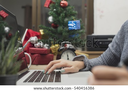 workplace with modern computer and gift box, christmas tree on desk office.