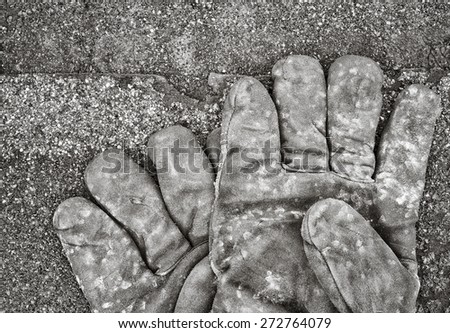 Work gloves lying on shingles. Black and white image.
