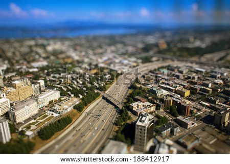 Tilt shift photo of busy interstate highway with cars during sunny day