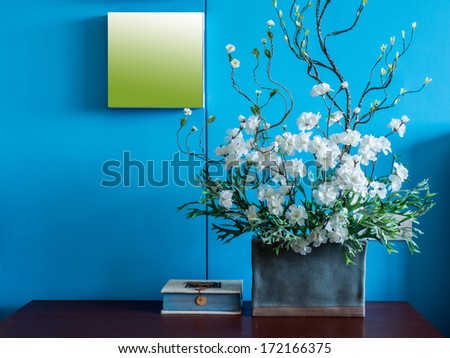 Colorful modern interior wall decorate with artificial flowers in ceramic vase