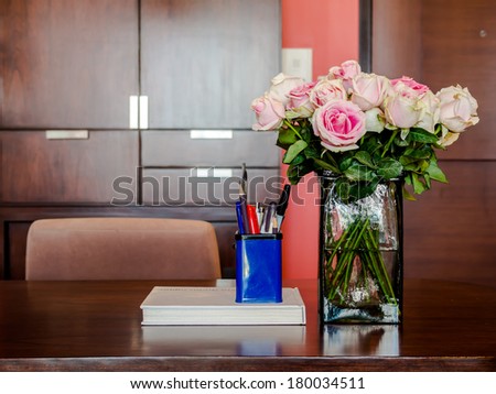 Working table with vase of roses in modern room