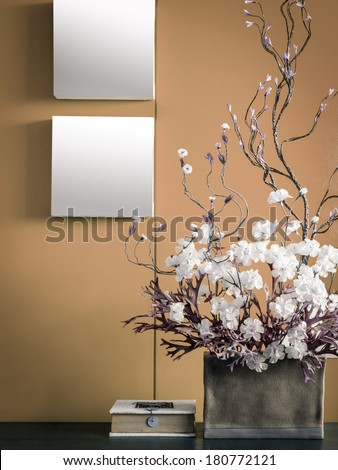 Blank modern interior wall decorate with artificial flowers in ceramic vase