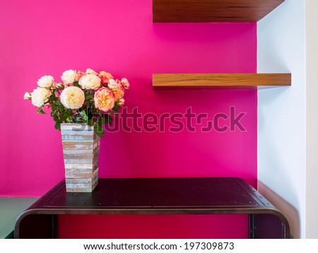 Magenta modern interior wall with artificial flowers in rustic wooden vase