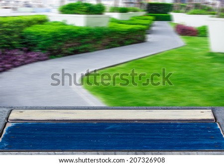 Rustic wooden planks over blurry modern roof garden background