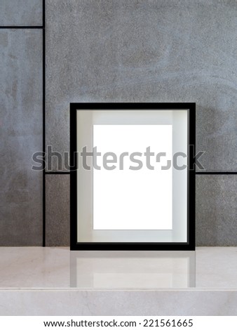 Modern interior wall background with blank black picture frame