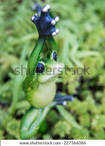 Frog figurine as yoga pose ornamental in garden