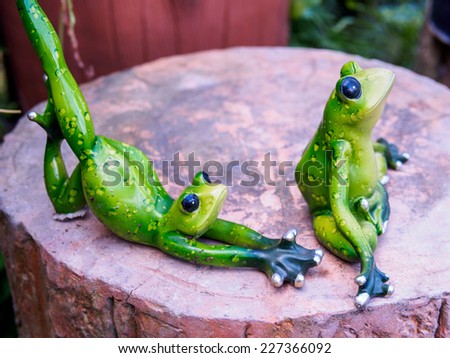 Frog figurine as yoga pose ornamental in garden