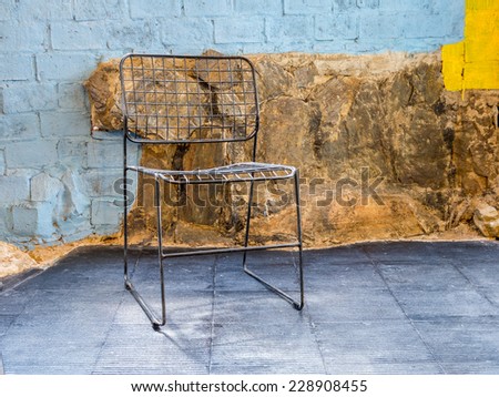 Interior design of  chair with rustic stone and brick-wall  background