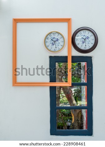 Interior design of picture frame with clocks over white wall background