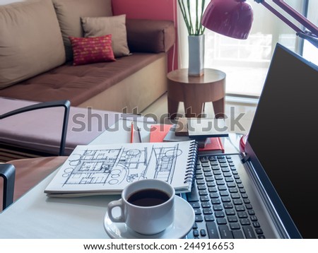 Open laptop with architectural drawing  and color sample on desktop in modern office