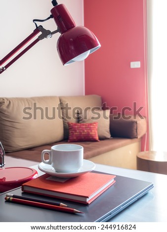 Laptop with coffee cup on desktop in modern office background