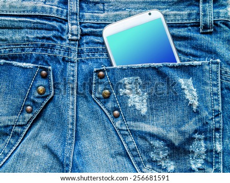 Closeup of mobile phone in blue jeans back pocket with blank screen