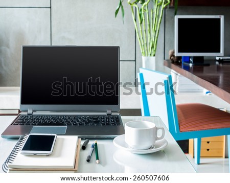 Modern workspace with laptop computer and notebook on desktop