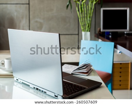 Modern workspace with laptop computer and sketch book on desktop