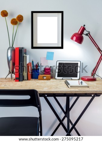 Modern creative workspace with tablet computer on compressed plywood chipboard table top