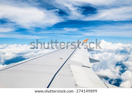 Looking through window aircraft during flight in wing blue sky
