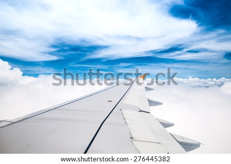 Looking through window aircraft during flight in wing blue sky