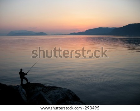 Person fishing at sea shore.
