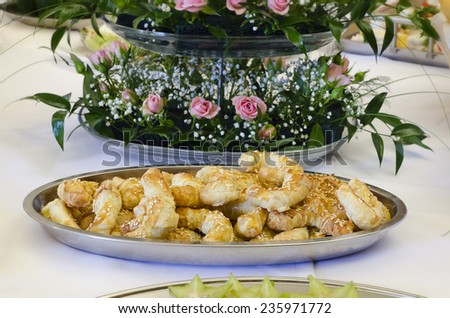 Bread rolls or stick on a wedding or party table with flowers or floral decoration.