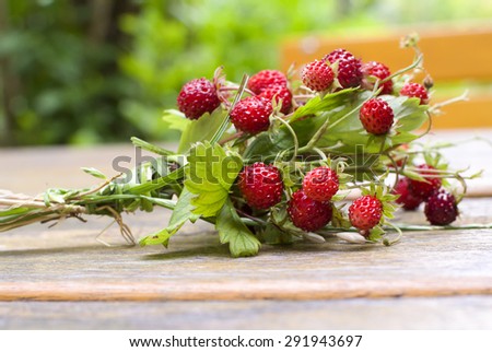 Wild strawberry bouquet on garden table