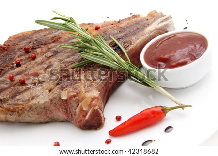 Rib-eye steak resting on a white plate