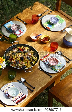spanish style dining table with paella, overview, vertical