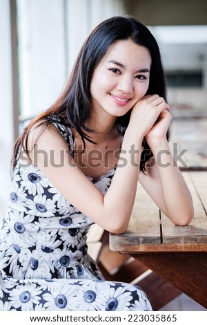Young lady sitting on wooden bench