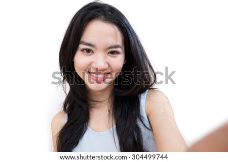 An asian woman taking self portrait isolated on white