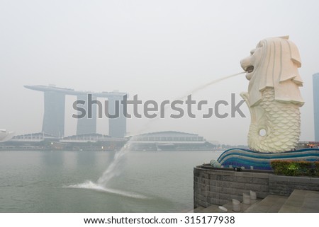 Singapore - 10th September, 2015: Haze fills the Marina Bay area. Haze is caused by the forest fire and burning of plantation in Indonesia. Visible is the Merlion statue and Marina Bay Sands hotel.