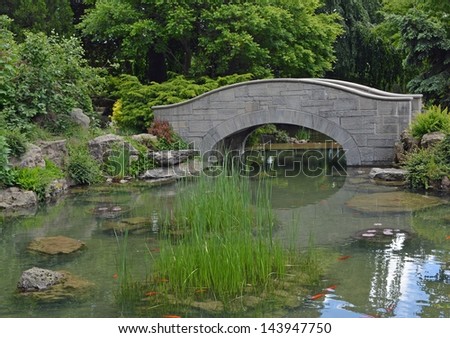 stone foot bridge over a Koi pond at the city park in Niagara Falls, Ontario