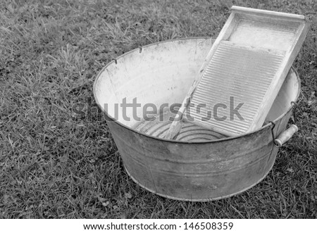 old fashioned laundry equipment, washboard and tub beside , black and white