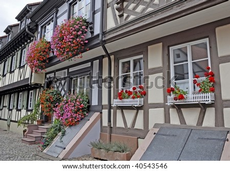 historical houses decorated with geraniums on back street in Gengenbach Germany